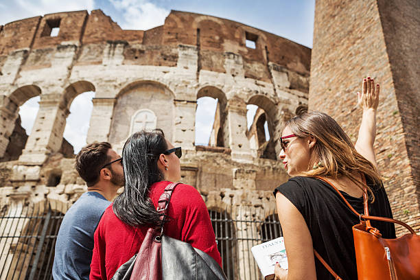 Tourists with a guide in front of the Coliseum, Rome